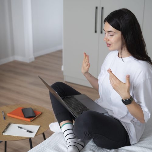 woman-talking-using-her-laptop-home-quarantine